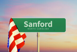 Sanford – North Carolina. Road or Town Sign. Flag of the united states. Sunset oder Sunrise Sky. 3d rendering