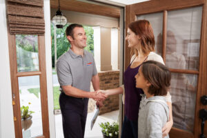 AC Repair Technician shaking hands with homeowner