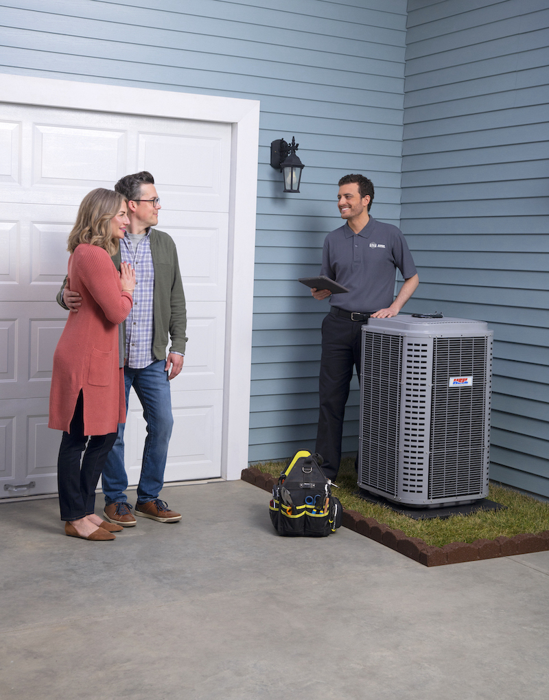 Couple by AC Unit with AC Service Technician